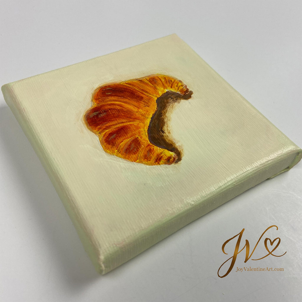 Mini Painting Le Petit Croissant original acrylic painting angled lay flat by Joy Valentine